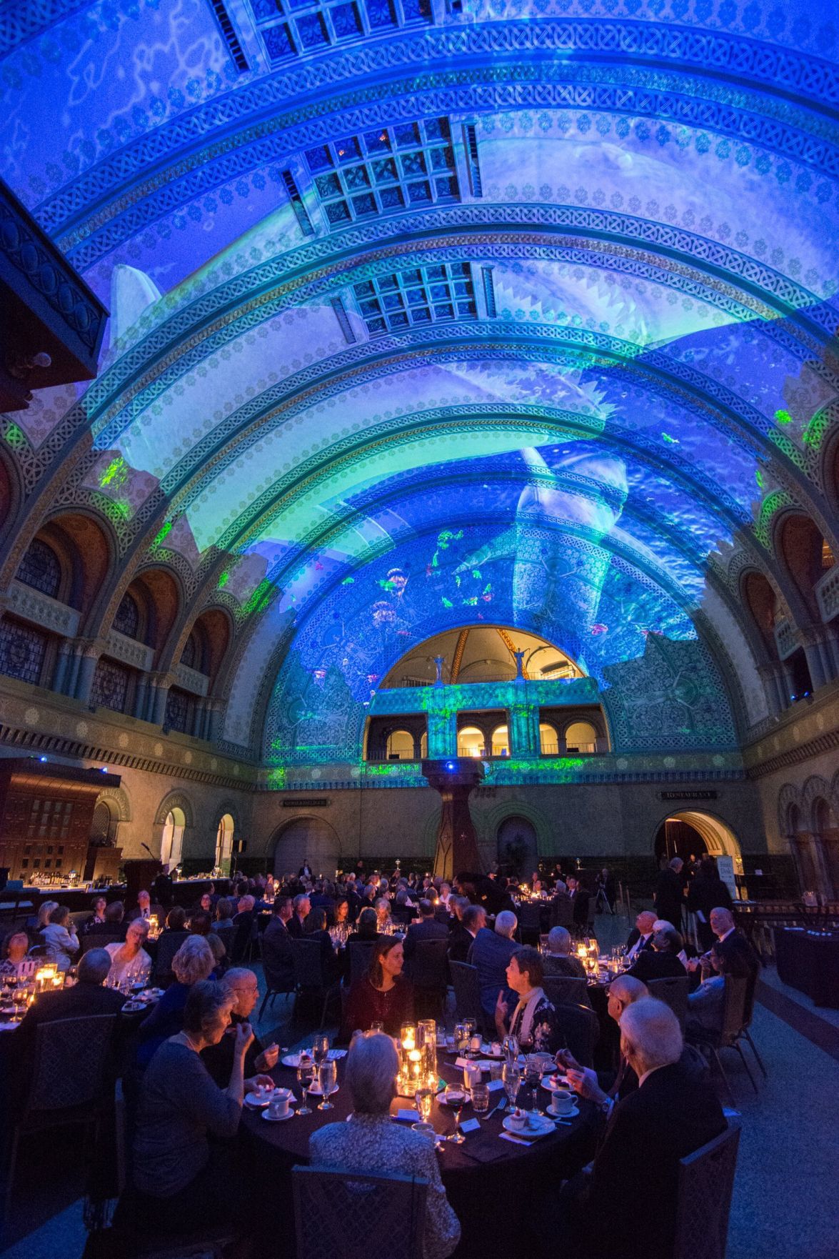 Guests have dinner during the light show on the ceiling of the Grand Hall in Union Station